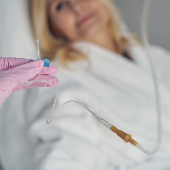 Gloved hands of qualified doctor holding intravenous catheter for skin resurfacing