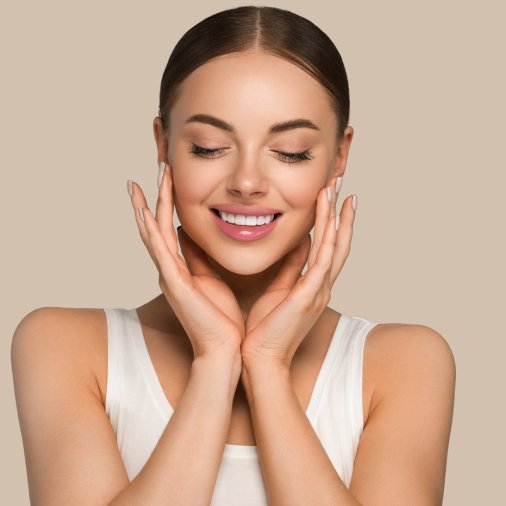 Beautiful skin face woman natural make up healthy skin touching her face. Color background. Brown